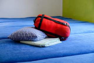 Ein Bild von Schlafsack, Kopfkissen und Bettlaken